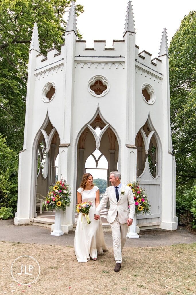 Couple at a Painshill Park wedding, captured by a Surrey wedding photographer outside the Gothic Temple.