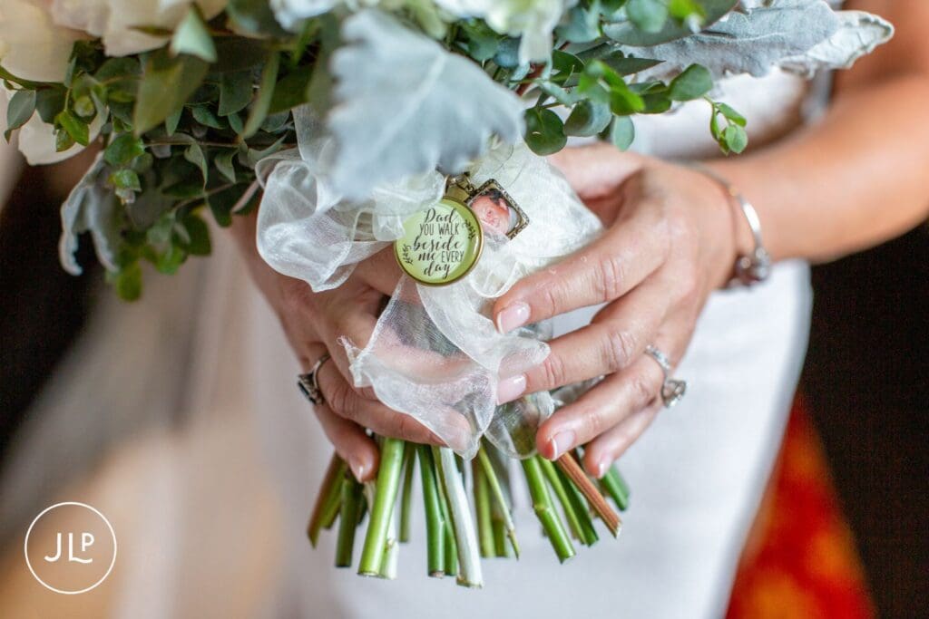 Close up of bridal bouquet charms captured by a documentary wedding photography specialist in Cheshire.