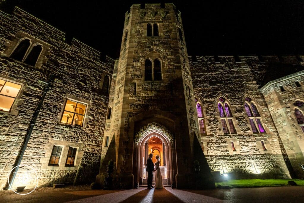 Dramatic night portrait by a Peckforton Castle wedding photographer at a luxury castle wedding.