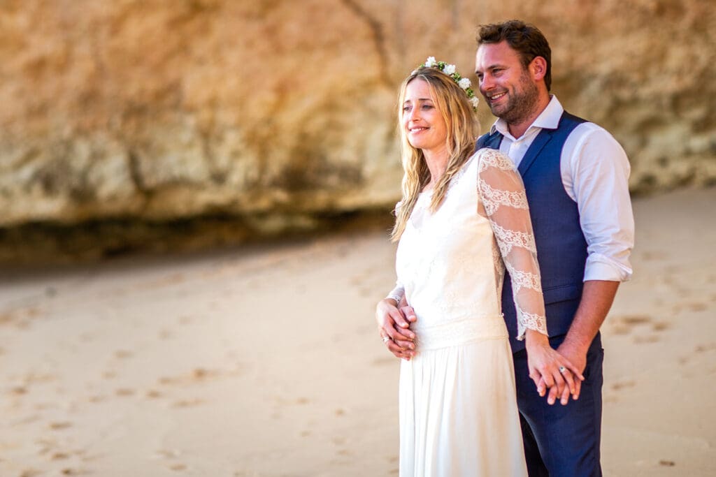 A quiet embrace during a post-wedding beach session in Portugal with an Algarve wedding photographer.