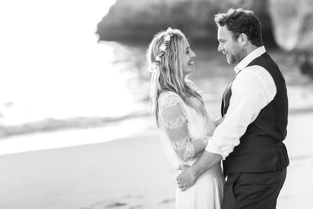 B&W intimate portrait of Ali and Matty laughing, captured by an Algarve beach wedding photographer in Portugal.