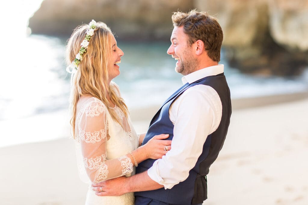 Real connection and laughter during an Algarve beach wedding photoshoot at golden hour.