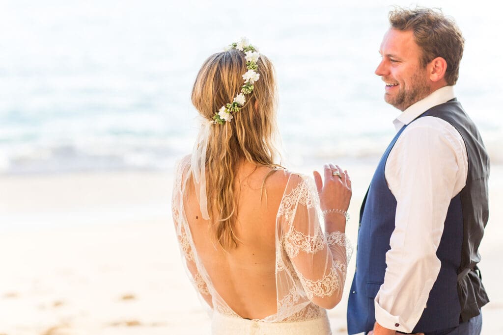 Detail of Ali’s lace wedding dress and flower crown during a beach wedding photography session.