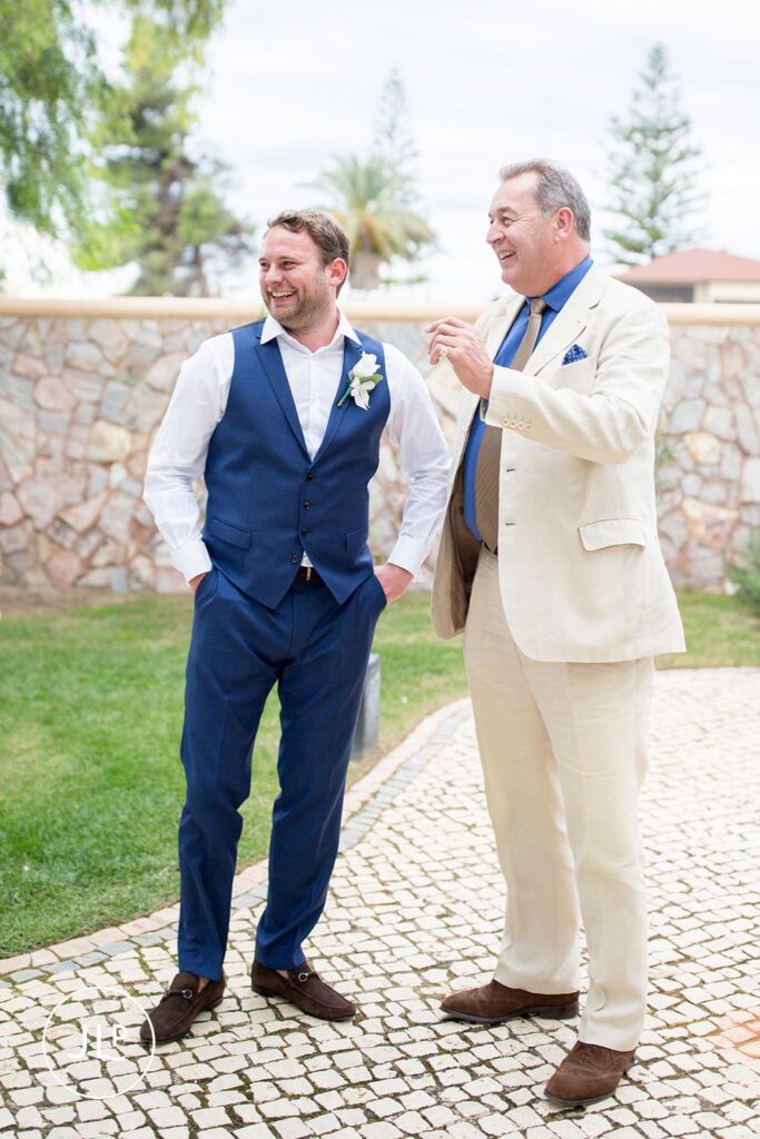Groom Matty sharing a laugh before the ceremony at his luxury Quinta dos Vales wedding in the Algarve.