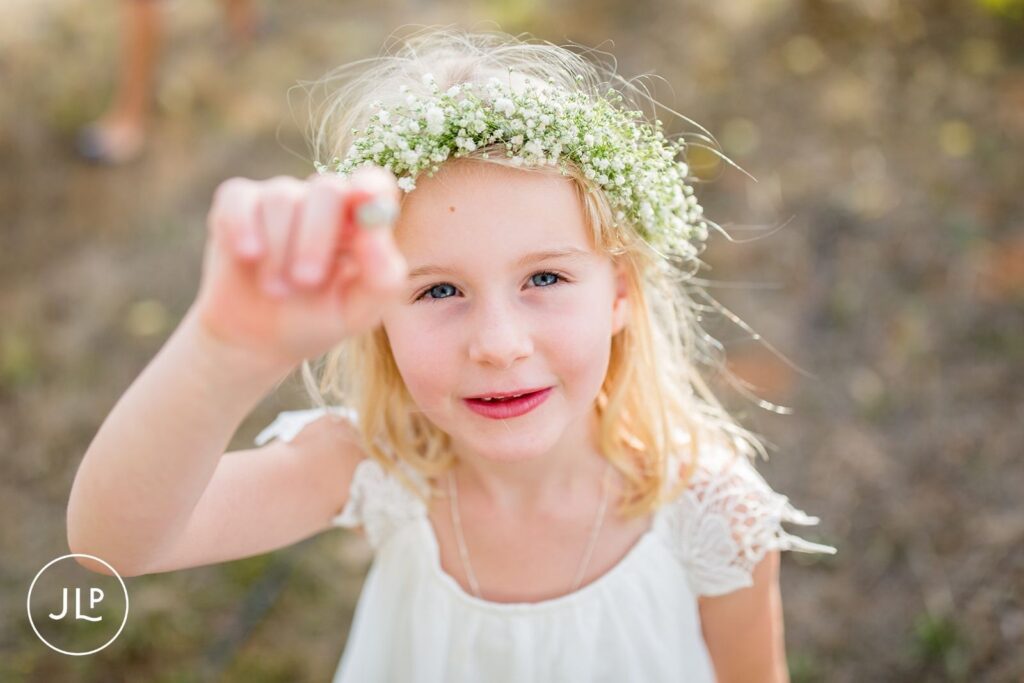 Cute close-up of a flower girl with a gypsophila crown at a luxury Algarve wedding in Portugal.
