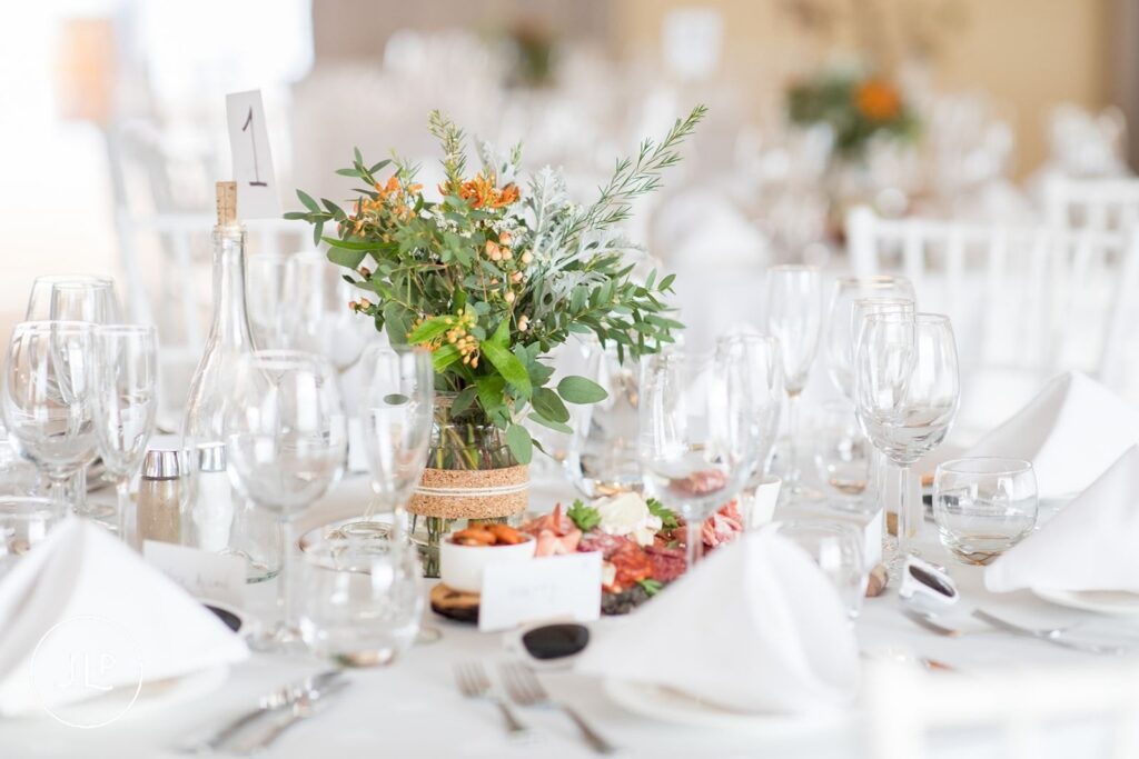 Elegant floral centerpieces and white table decor for a luxury Algarve wedding at Quinta dos Vales.