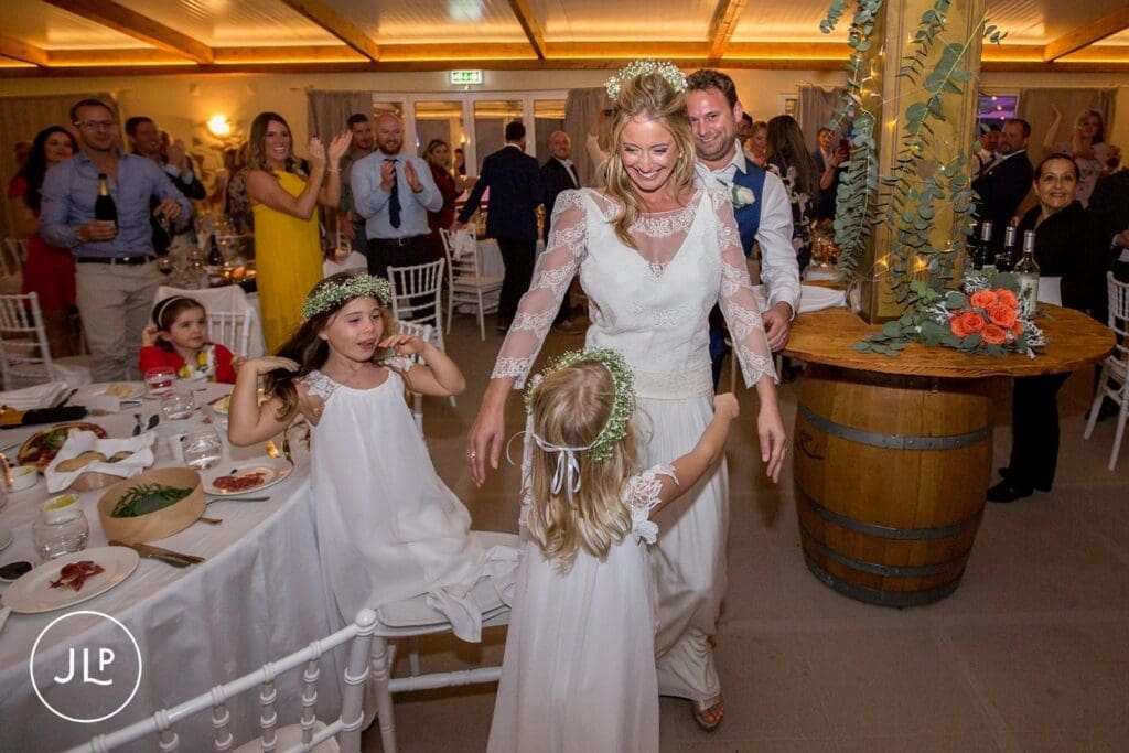 Ali dancing with young flower girls during her reception, a moment by a Portugal destination wedding photographer.