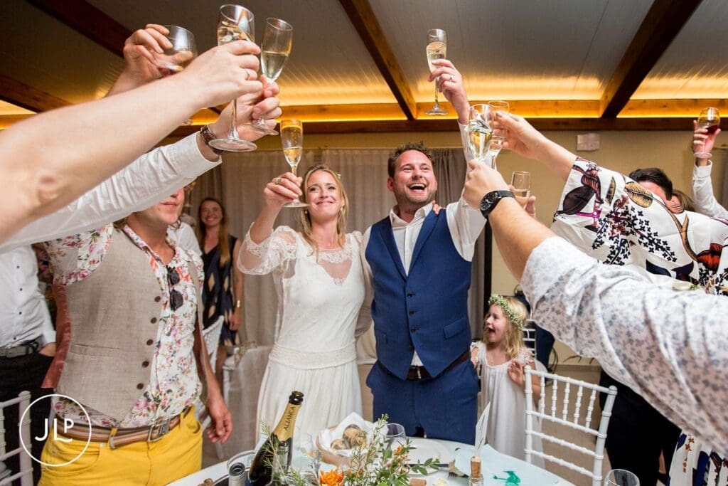 Ali and Matty toast with guests during an interactive wedding breakfast, a Portugal destination wedding photography moment.
