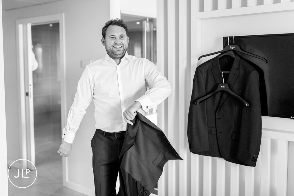 A happy groom getting ready for his Quinta dos Vales wedding, shot by a Portugal destination wedding photographer.