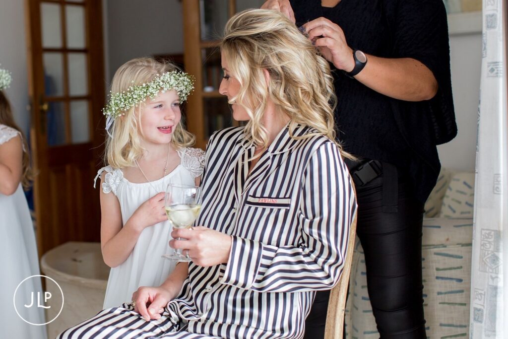 Heartfelt moment between Ali and a young flower girl during destination wedding preparations in the Algarve.