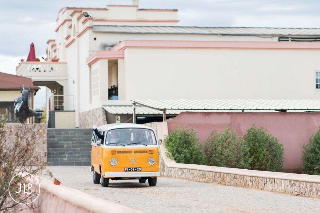 Yellow VW camper van arriving at Quinta dos Vales, a stylish touch for a destination wedding in Portugal.