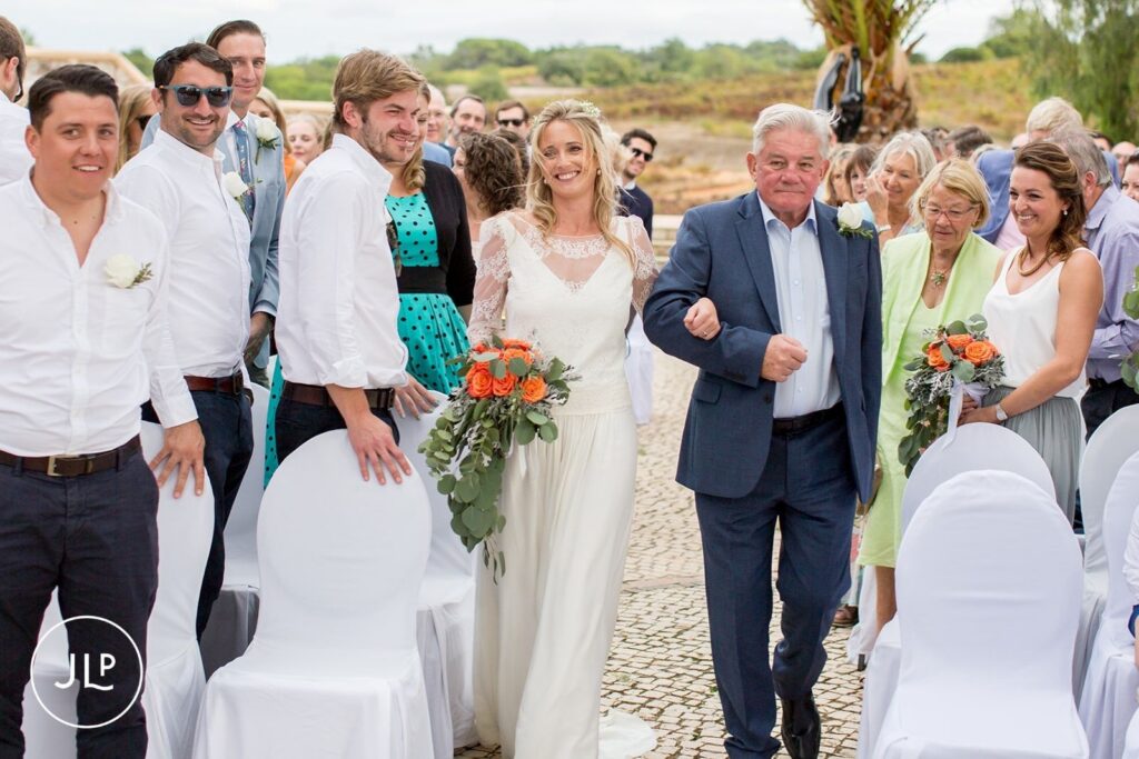 Ali walking down the aisle with her father during a luxury Algarve vineyard wedding at Quinta dos Vales.