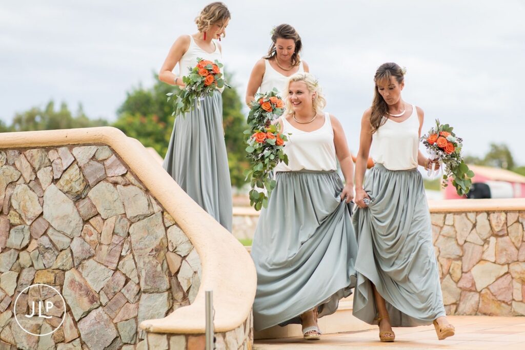 Bridesmaids in grey skirts and white tops arriving for a Quinta dos Vales wedding ceremony in the Algarve.