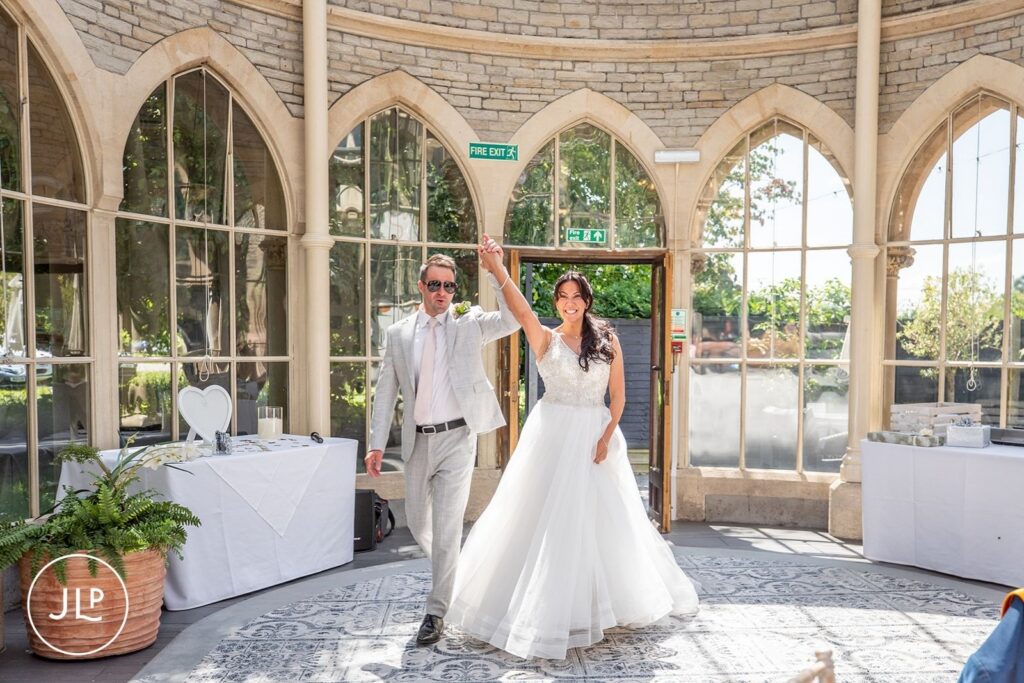 Mel and Ben entering their reception at De Vere Tortworth Court, a premier luxury Gloucestershire wedding venue.