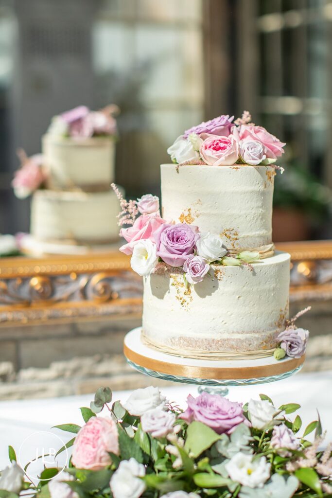 Two-tier floral wedding cake at De Vere Tortworth Court, a luxury Gloucestershire wedding venue.