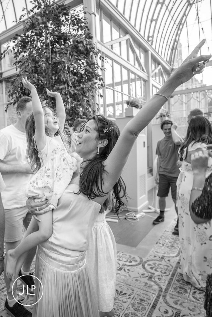 A joyful black and white candid moment during the evening party at this luxury Gloucestershire wedding venue.