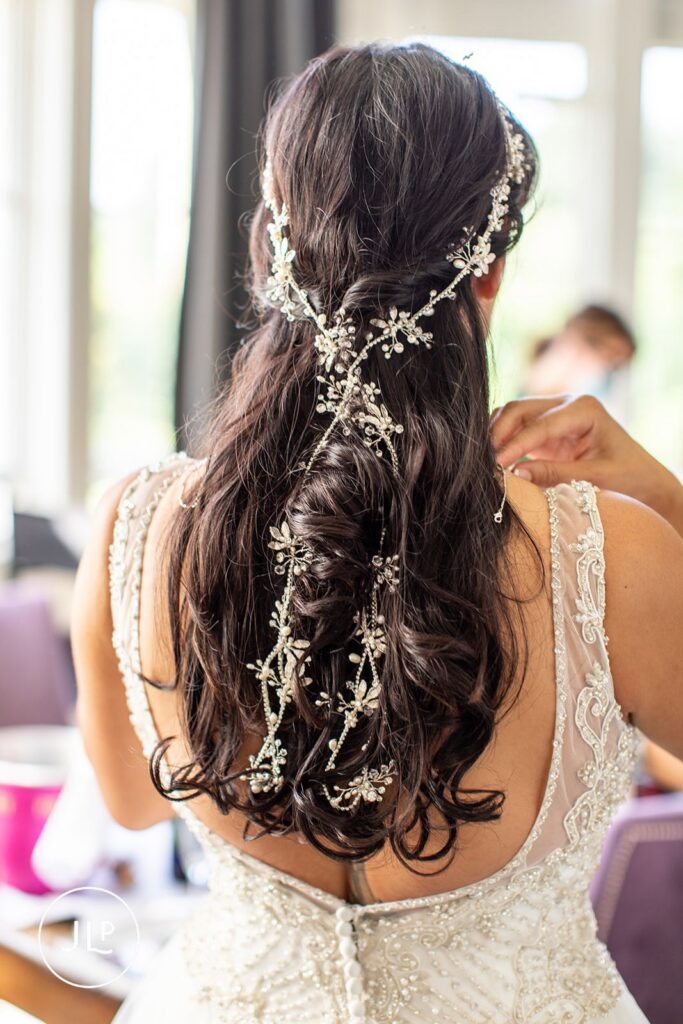 Detailed shot of Mel's elegant bridal hair and headpiece by a natural wedding photography Gloucestershire expert.