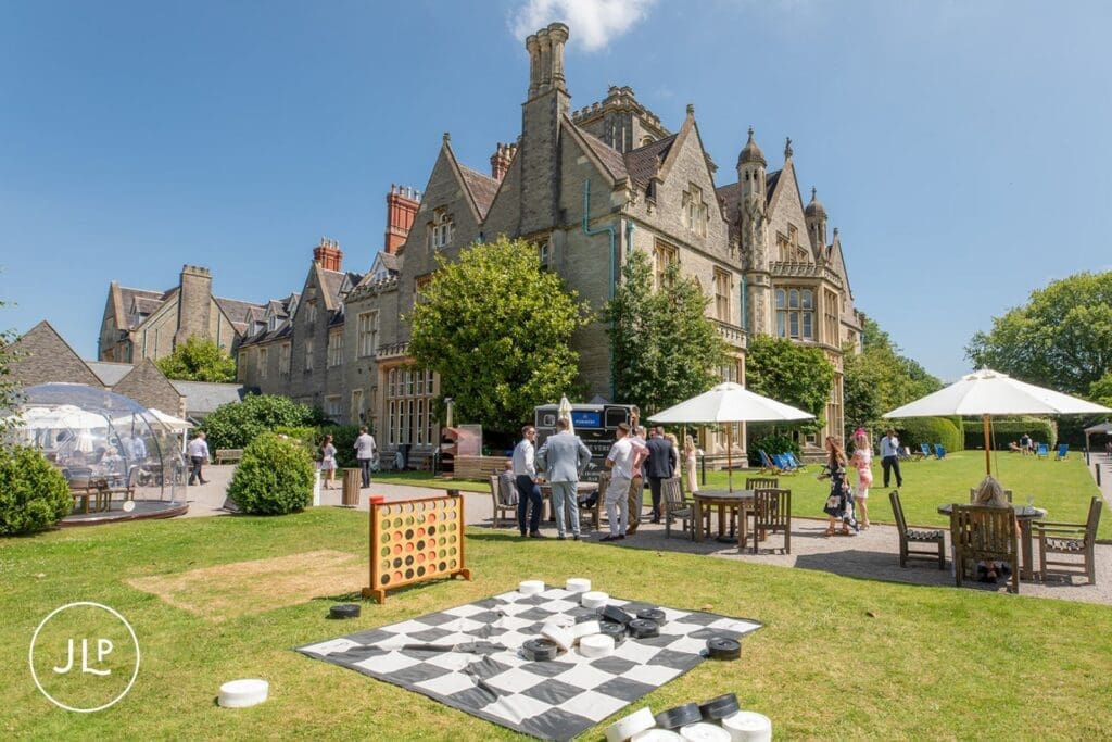 Wedding guests enjoying lawn games outside at a De Vere Tortworth Court wedding photography reception.