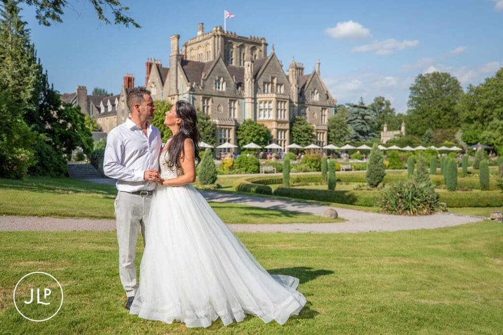 Bride and groom standing on the scenic grounds of a stunning Gloucestershire wedding venue.