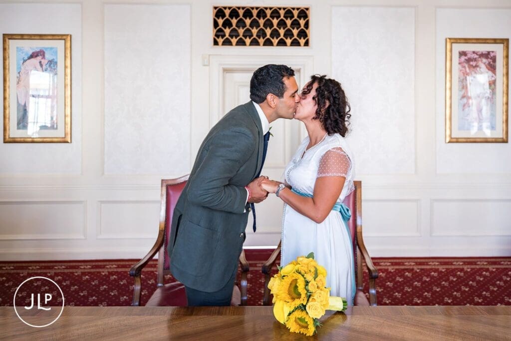 Newlyweds kiss during an intimate London wedding ceremony at Wandsworth Town Hall.