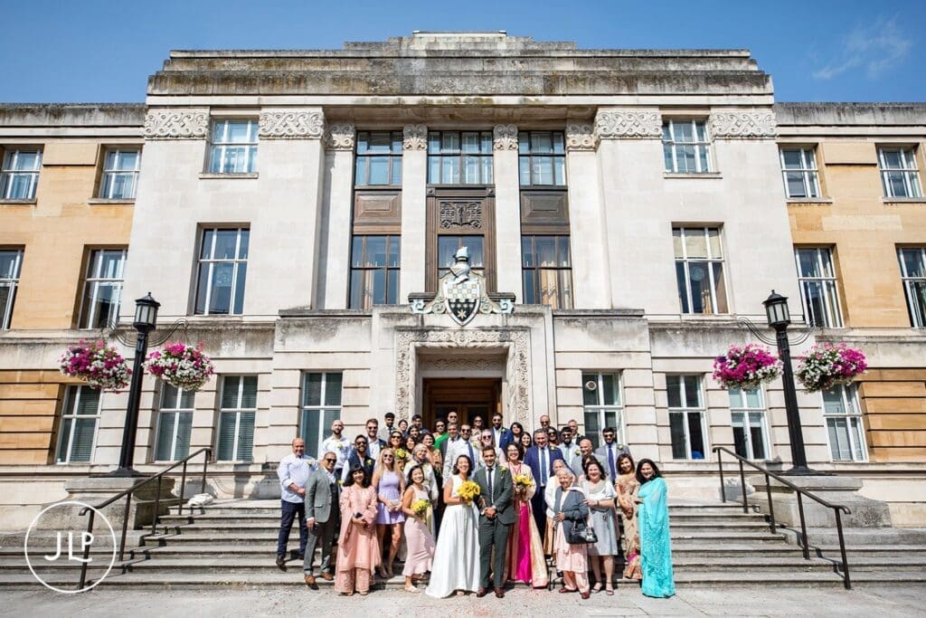 Large group photo on the entrance steps for a Wandsworth Town Hall wedding in London.