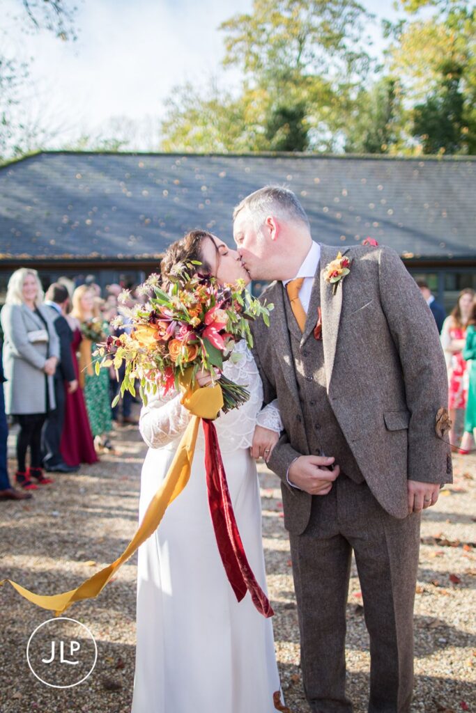 Wasing Park wedding photographer captures a candid close-up of the bride and groom kissing outdoors.