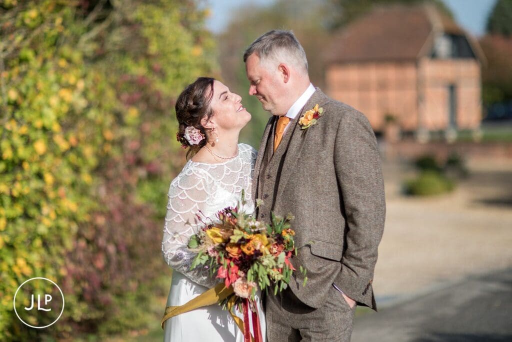 A stylish autumn wedding portrait of the couple at Wasing Park, a luxury countryside wedding venue.