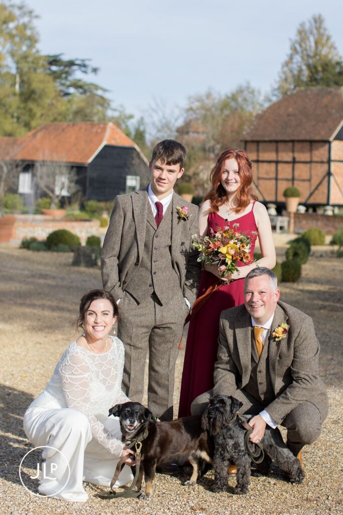 Relaxed wedding photography of a family portrait with their dogs at a Wasing Park Berkshire wedding.