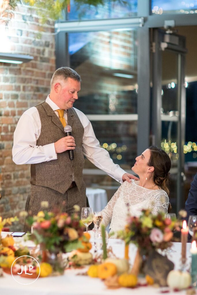 Groom giving an emotional speech to his bride, captured by an atmospheric documentary wedding photographer.