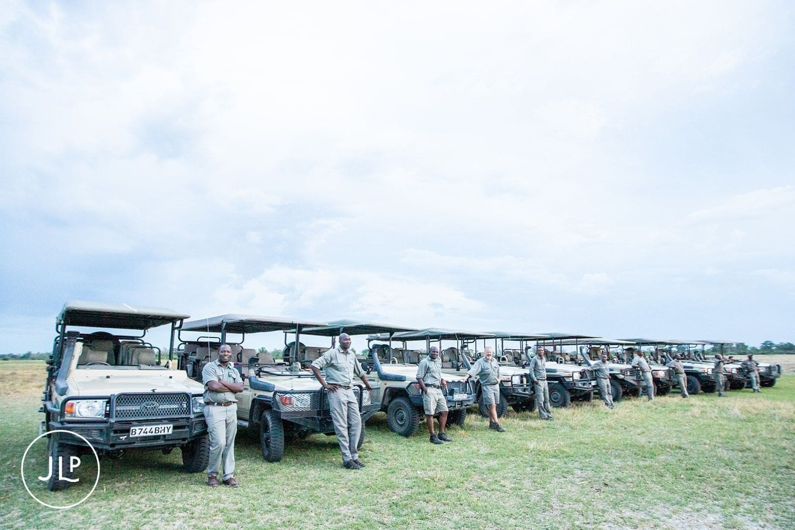 Safari vehicles lined up for guests at an unforgettable destination wedding in Botswana.