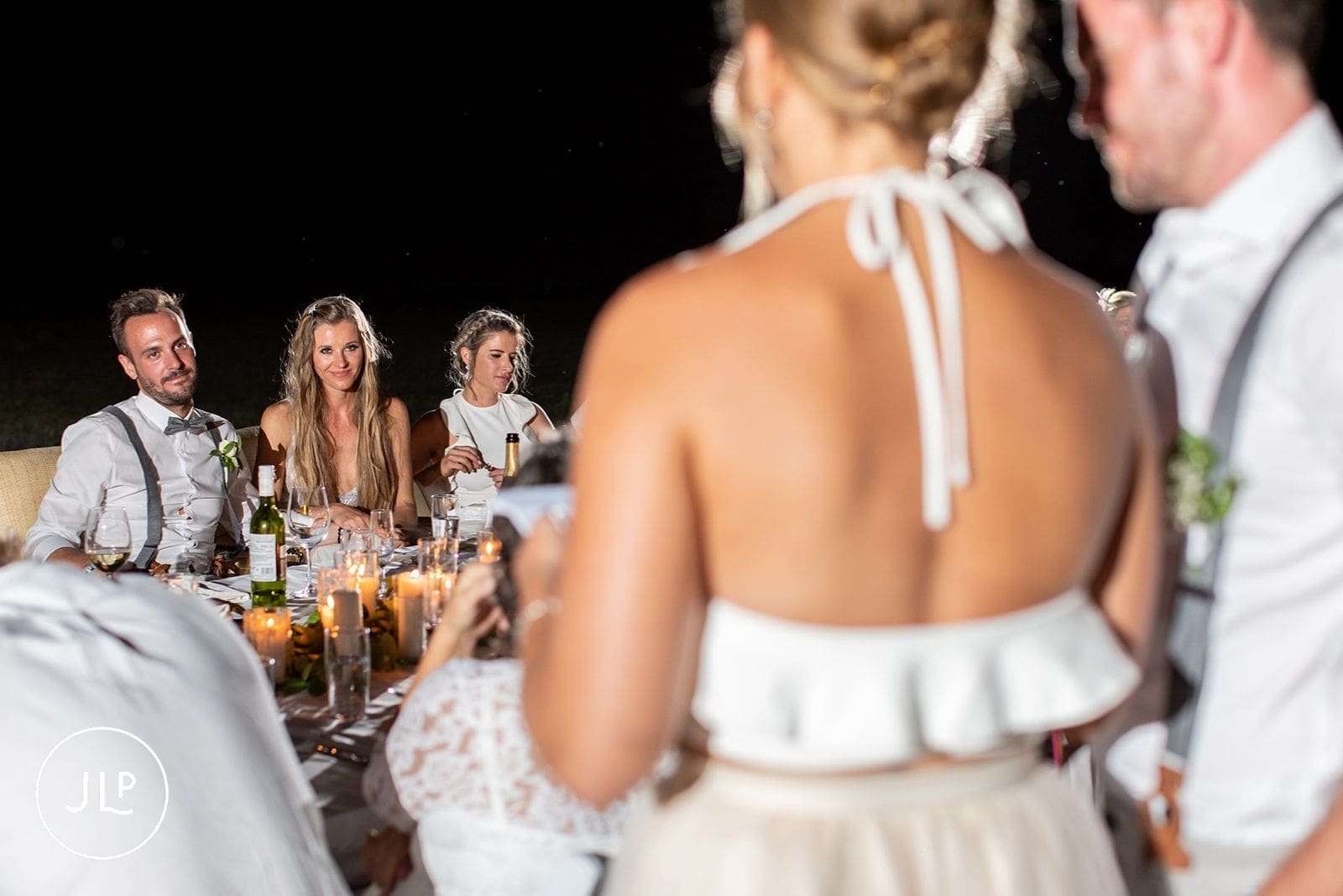 Guests looking at the bride and groom during speeches at a luxury safari wedding dinner.