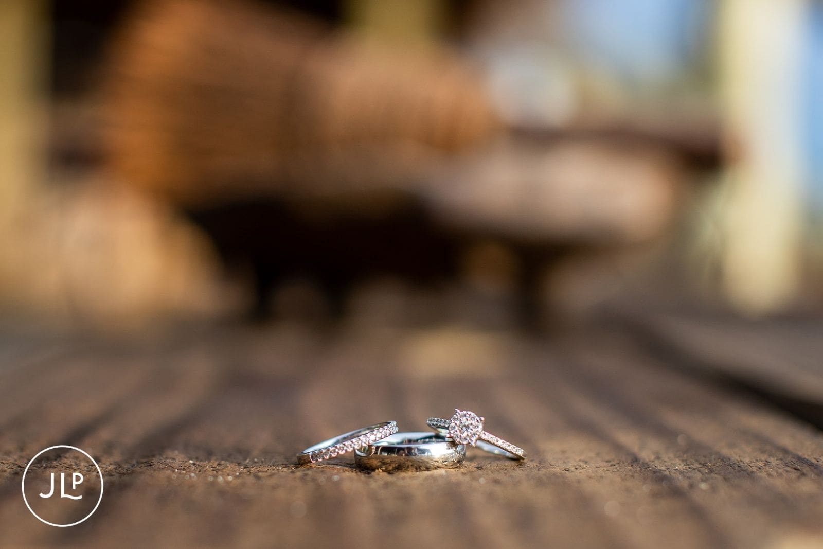 Close-up of diamond wedding rings on wood at a luxury safari venue in Botswana.