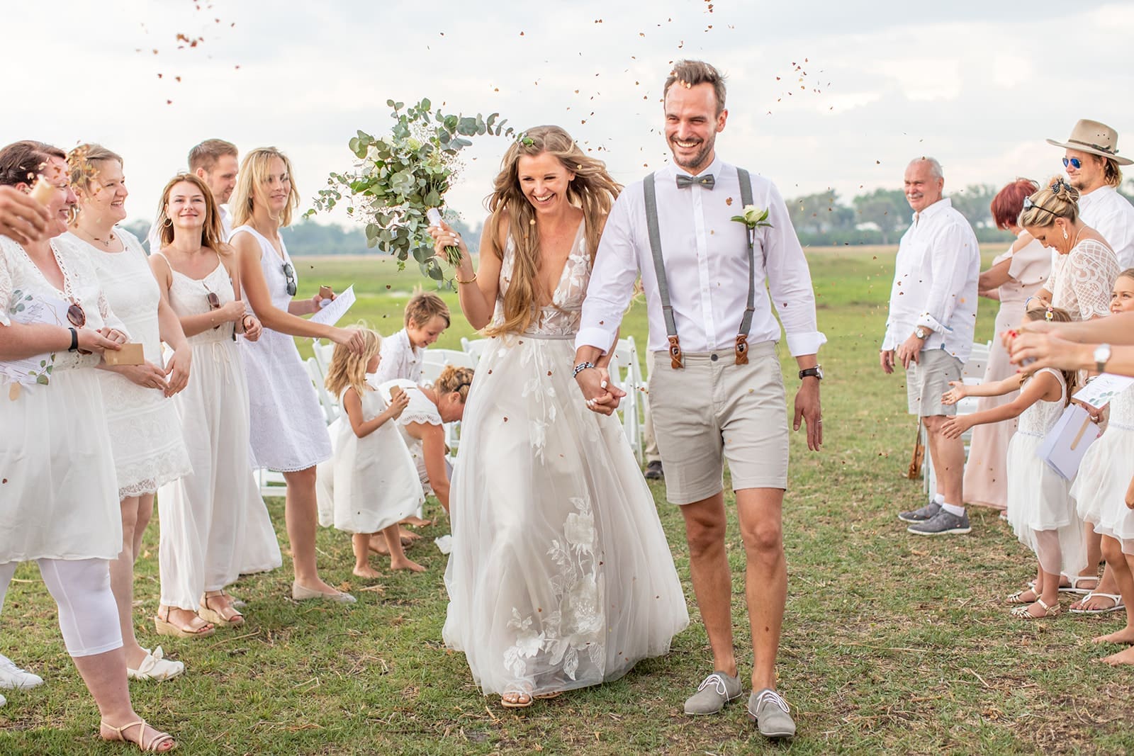 Bride and groom celebrate after a Botswana safari wedding ceremony.