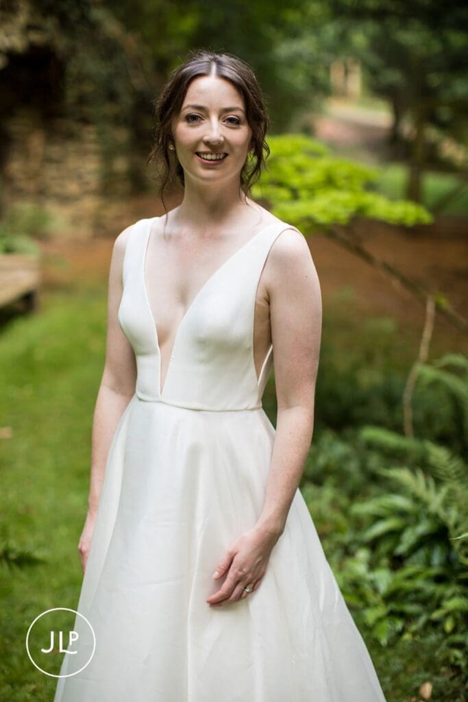 Portrait of a smiling bride in a modern gown, perfect marquee wedding inspiration.