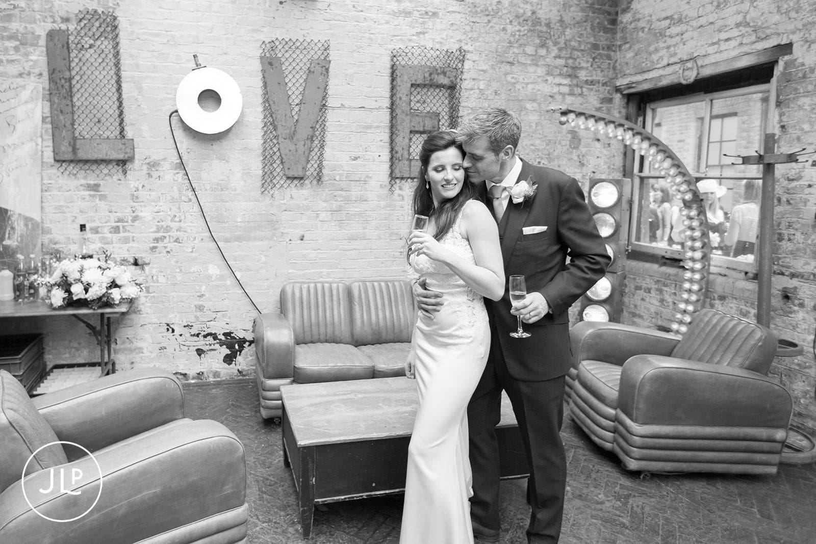 Candid moments of a couple inside a beautifully styled London warehouse wedding venue.