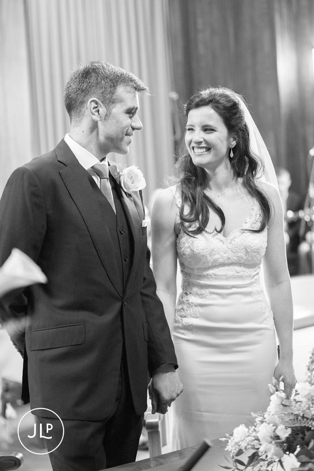 Happy bride and groom smiling at each other at an Islington Town Hall wedding.