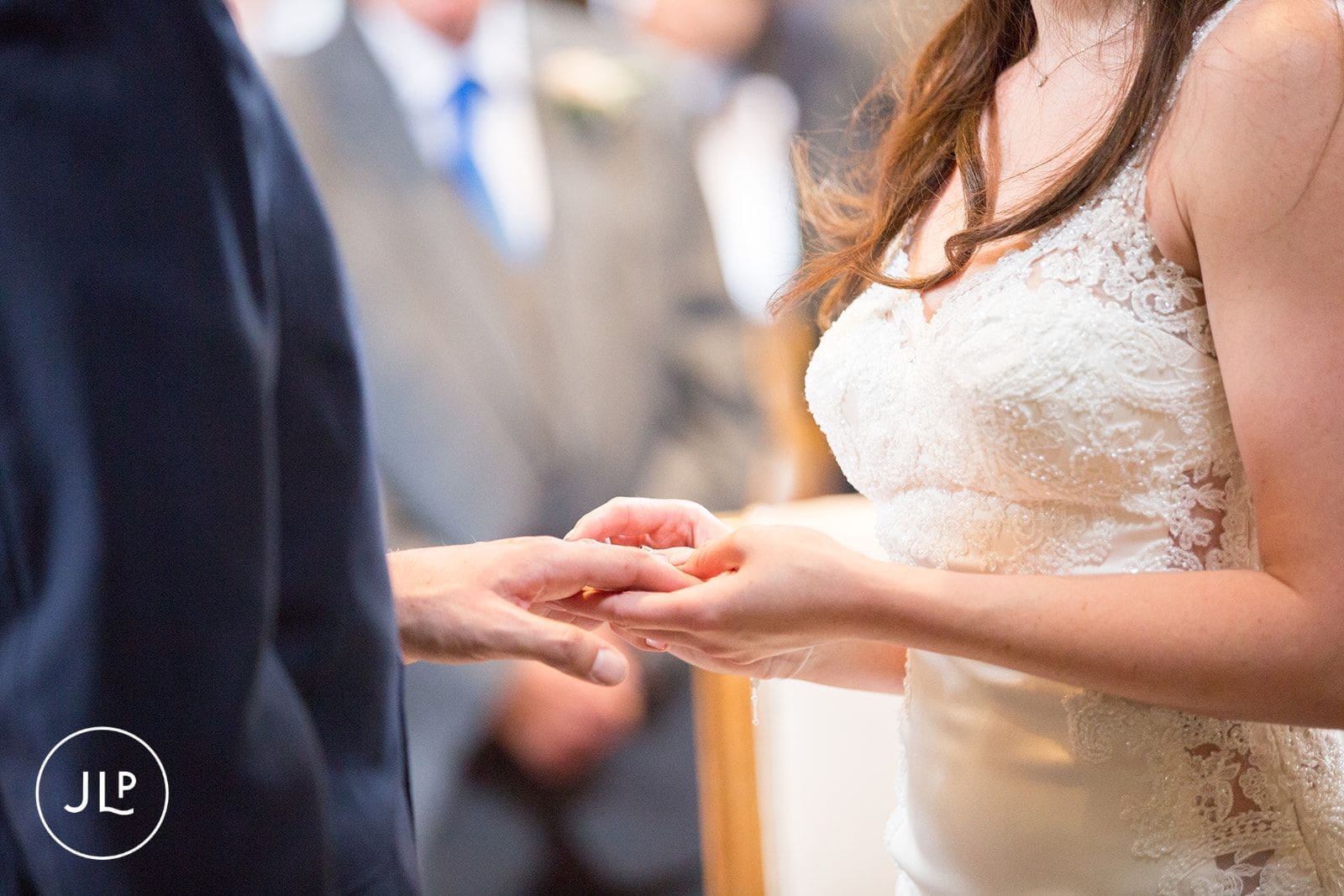 Close up of a bride and groom exchanging rings during an emotional London wedding ceremony.